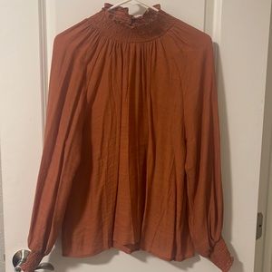 Orangish sheer blouse, high neck, Wood detail buttons on back of neck. Med size